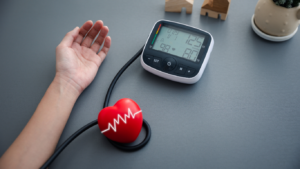 a person's hand is holding a blood pressure monitor