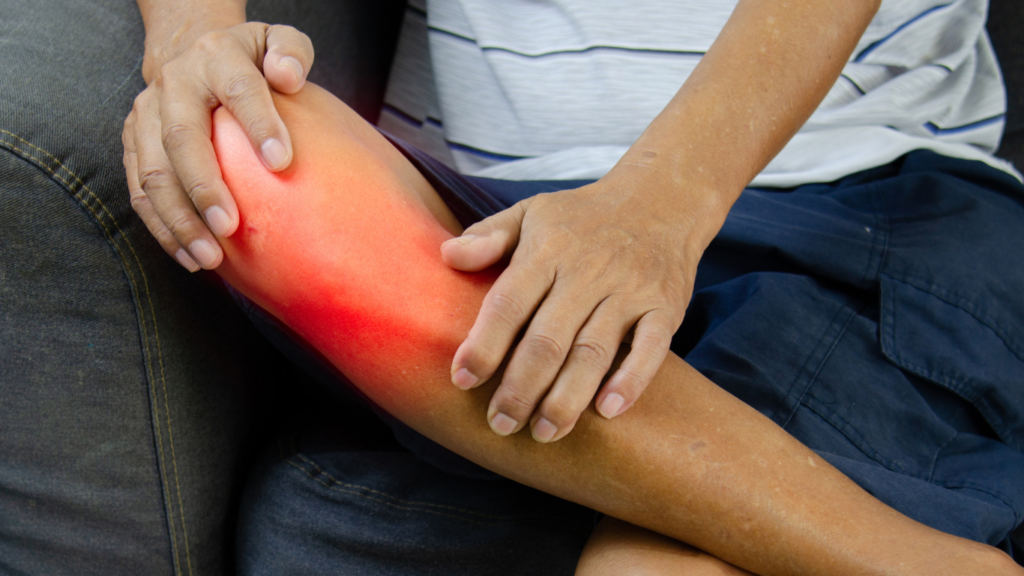 a person sitting on a couch with a painful knee