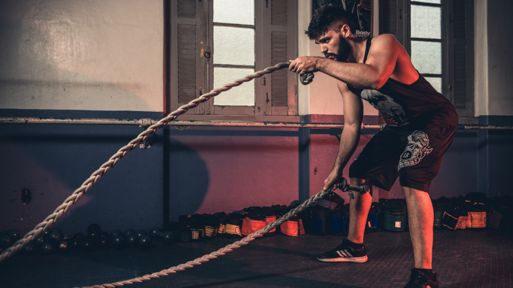 a person is pulling a rope in a gym