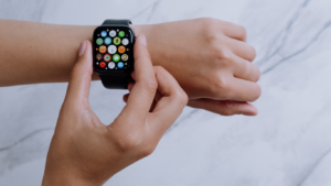 an apple watch is being held by a person's hand