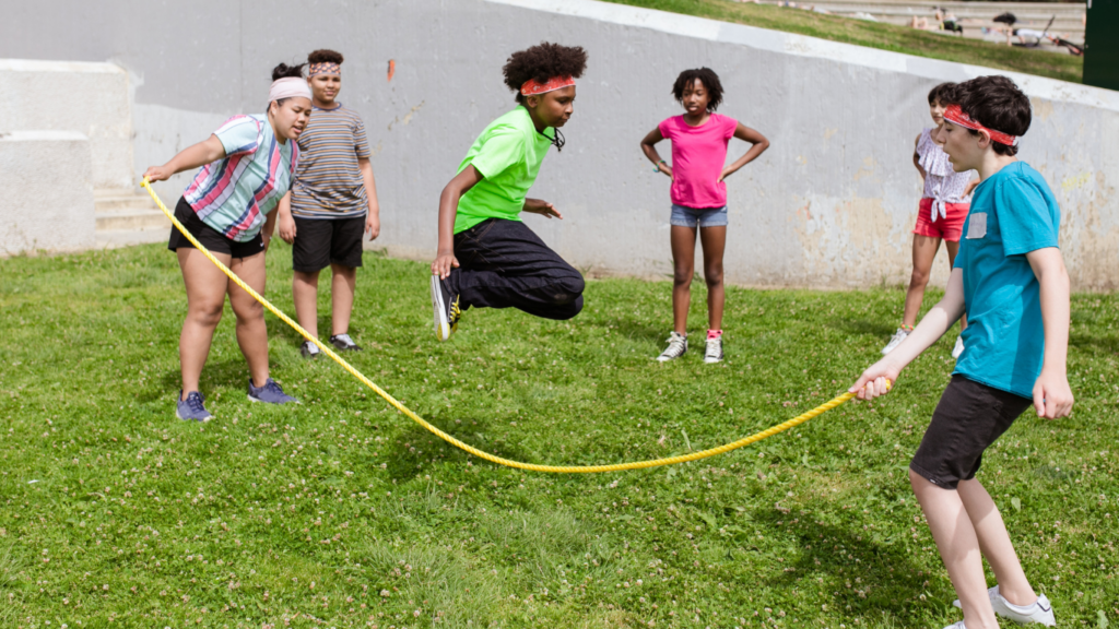 a group of kids playing with a skipping rope