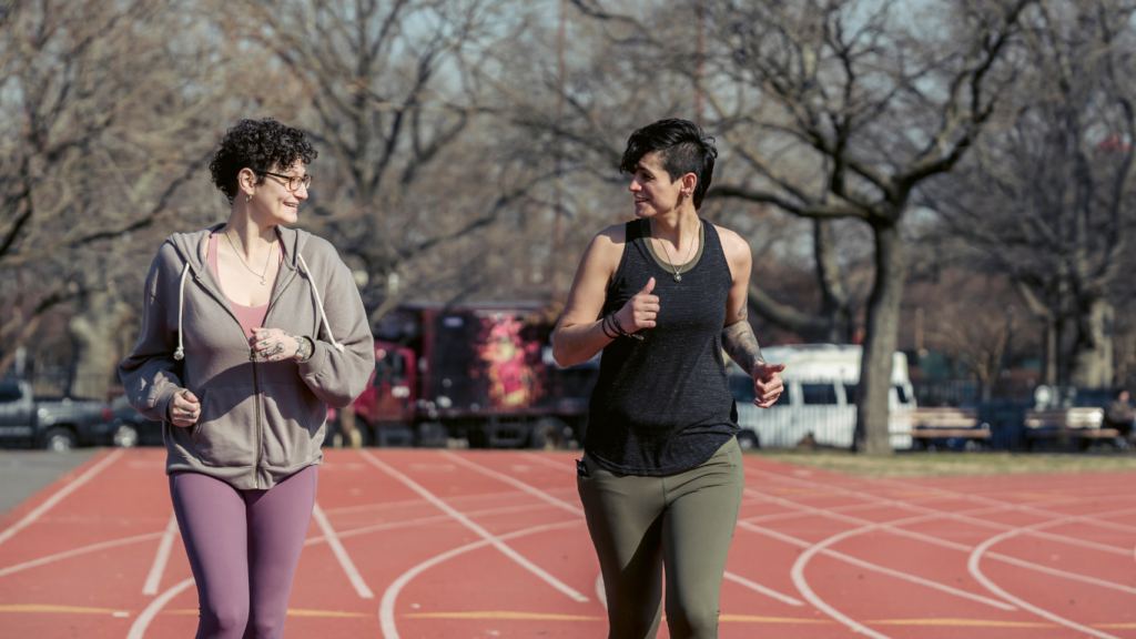 two people running on an outdoor track