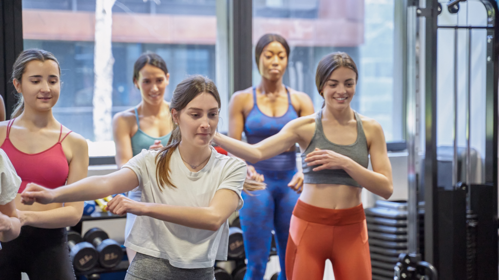 a group of individuals doing exercises in a gym