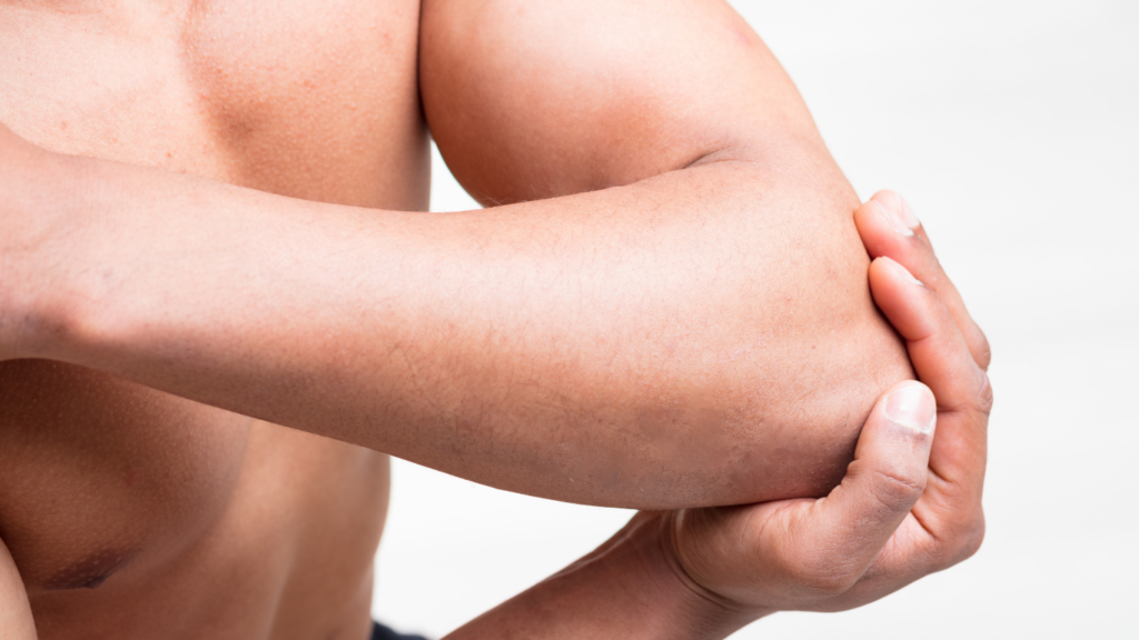 a close up of a person holding their elbow