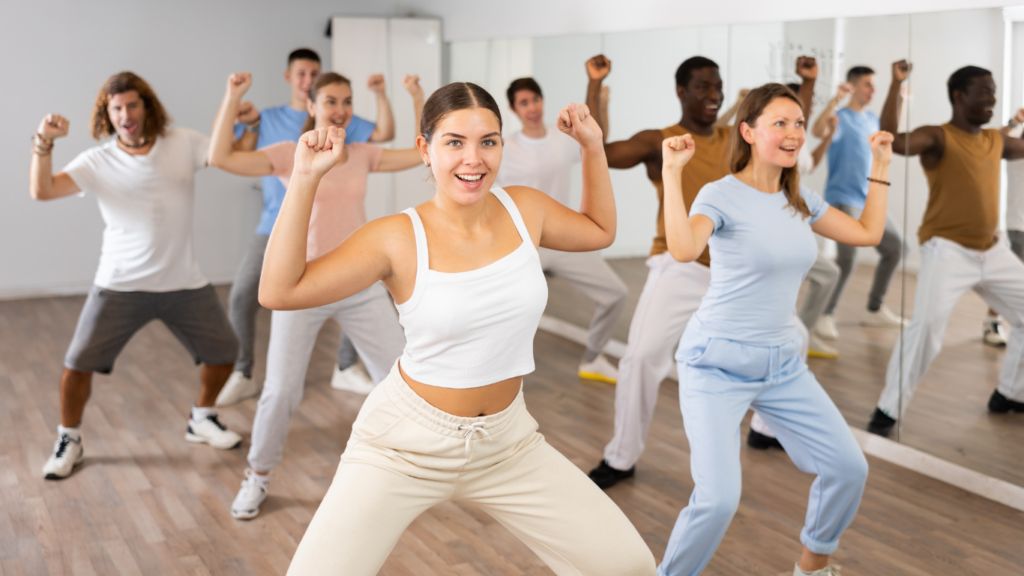 a group of individuals doing exercises in a gym