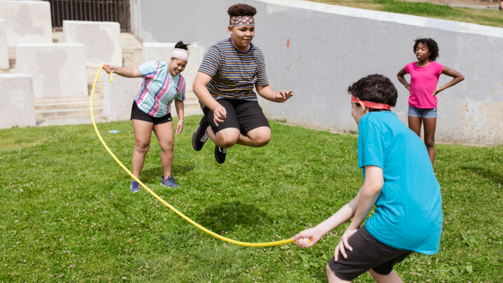 a group of kids playing with a skipping rope