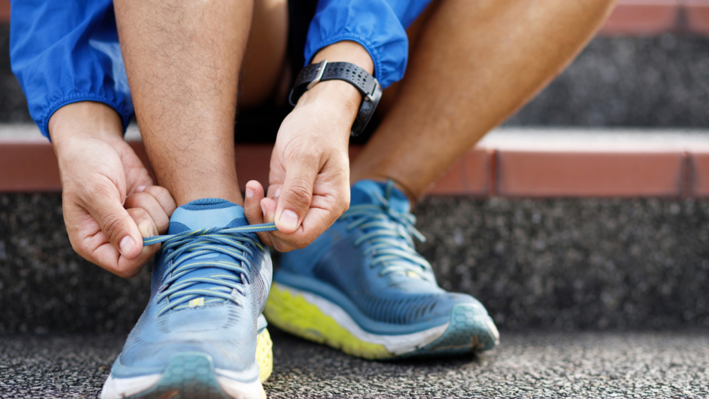 a person is tying their shoes on the side of the road