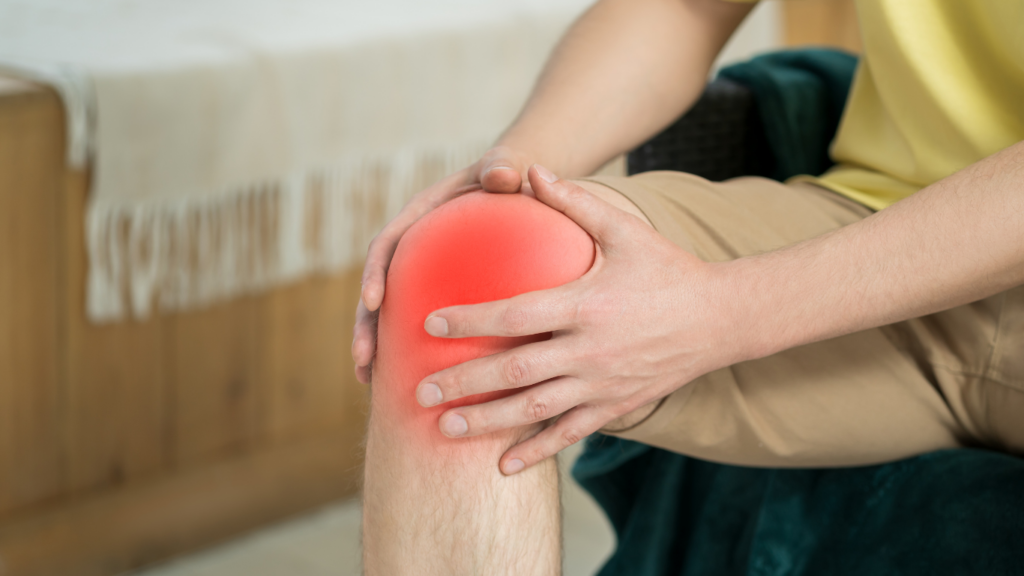 a person sitting on a couch with a painful knee