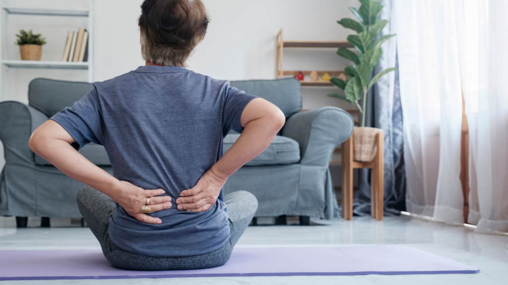 a person sitting on a yoga mat in front of a couch