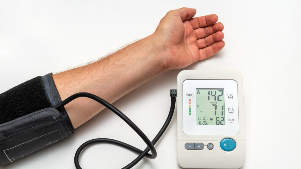 a person's hand is holding a blood pressure monitor