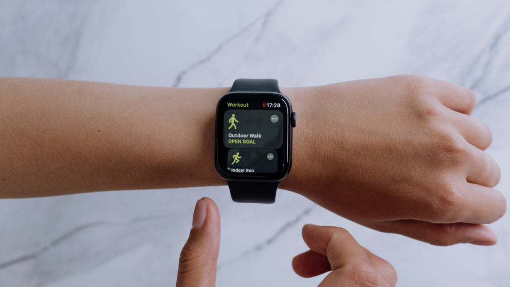 an apple watch is being held by a person's hand