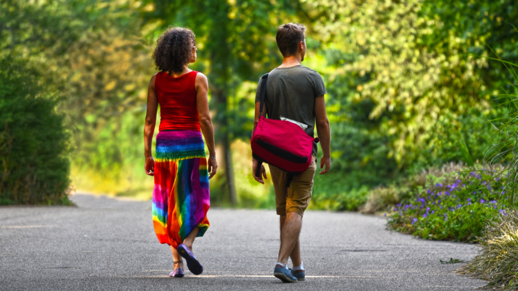 people walking down a path in the park