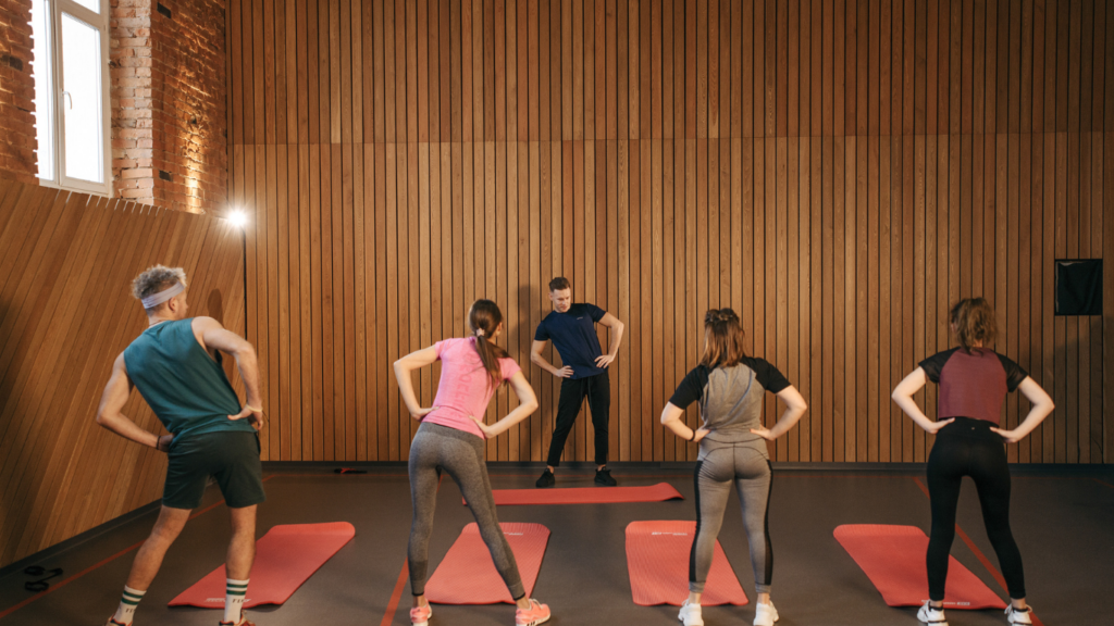 three people are doing exercises in a gym