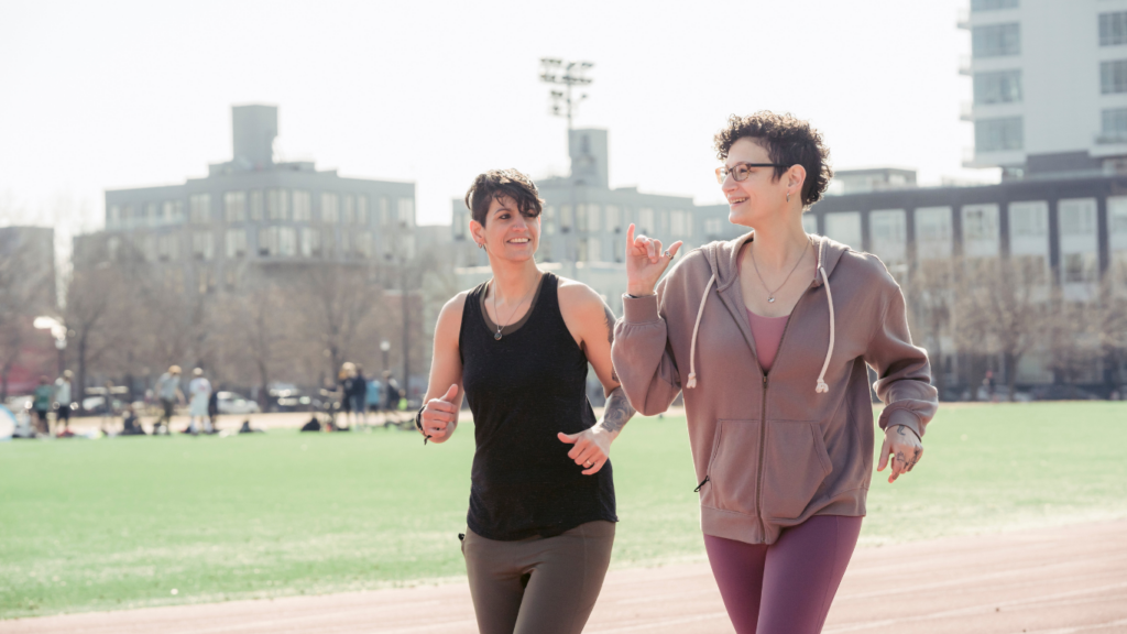 two people running on an outdoor track